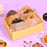 6 x Filled New York Cookies, The Stuffed Centre Box with six chunky cookies in a yellow box on a purple background